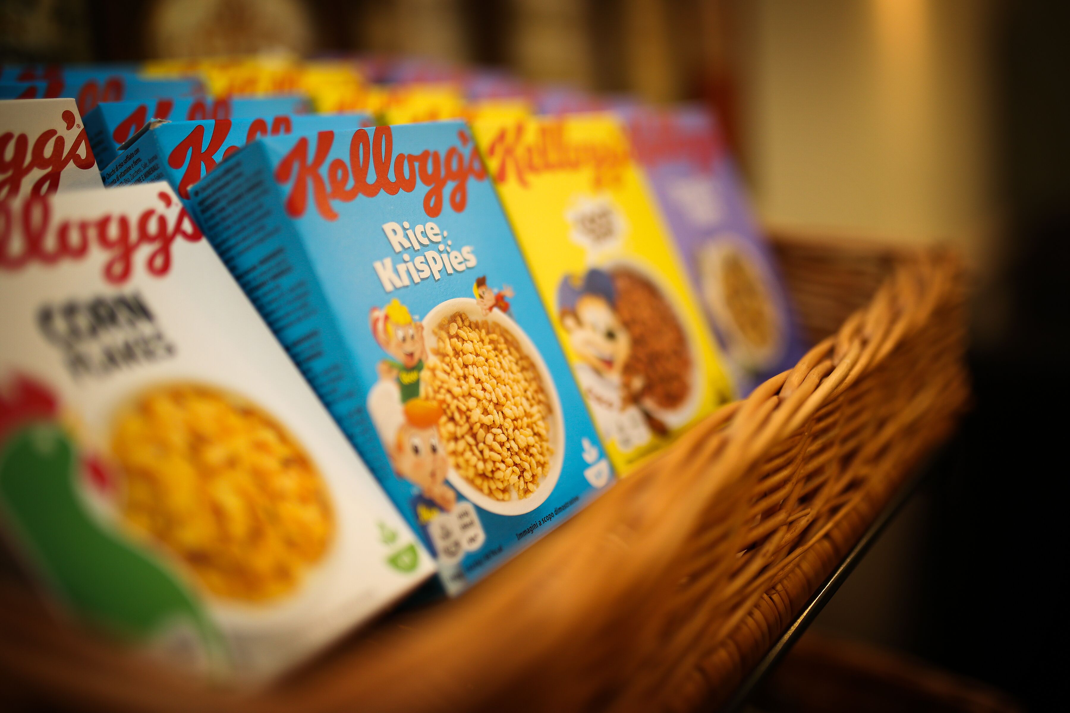 A close-up of cereal boxes in a basket.