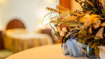 A close-up of a decorative arrangement with a ribbon and dried flowers.