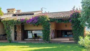 A house with a patio, outdoor seating, and a view of the landscape.