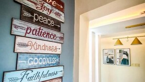 A wall with wooden signs displaying positive words like 'love', 'joy', 'peace', 'patience', 'kindness', 'goodness', 'faithfulness', 'gentleness', and 'self-control'. - Overlooking (Antipolo)