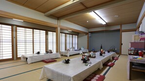 A traditional Japanese room with tatami mats, low tables, and sliding doors. - Minshuku Unzen (Unzen)