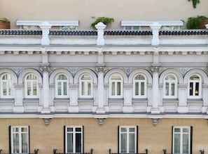 A building with a classical facade, featuring arched windows and decorative moldings.