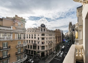 A multi-story building with a classical architectural style, featuring ornate balconies and a central entrance.
