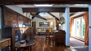 A traditional kitchen with wooden cabinets, a dining table, and a sofa. - A Romantic Retreat in Florence.  (Firenze)