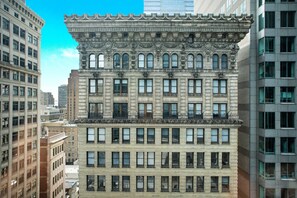 A multi-story building with a classical architectural style, featuring ornate detailing and large windows.
