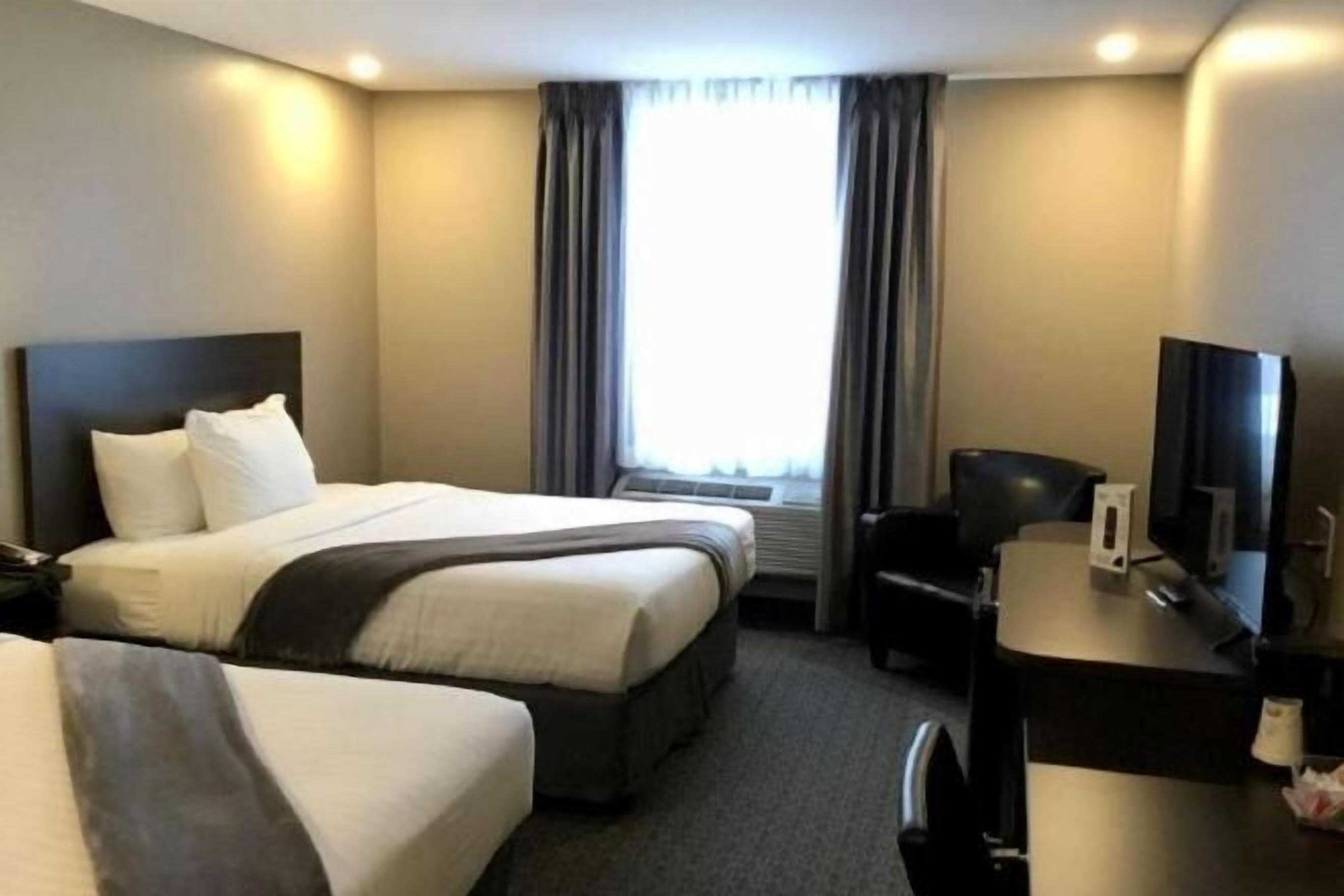 Hypo-allergenic bedding, desk, laptop workspace, blackout drapes