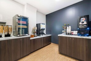 Enjoy a convenient kitchenette with a beverage dispenser, coffee machine, and Nespresso machine.