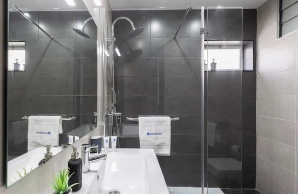 Shower, hair dryer, towels, shampoo