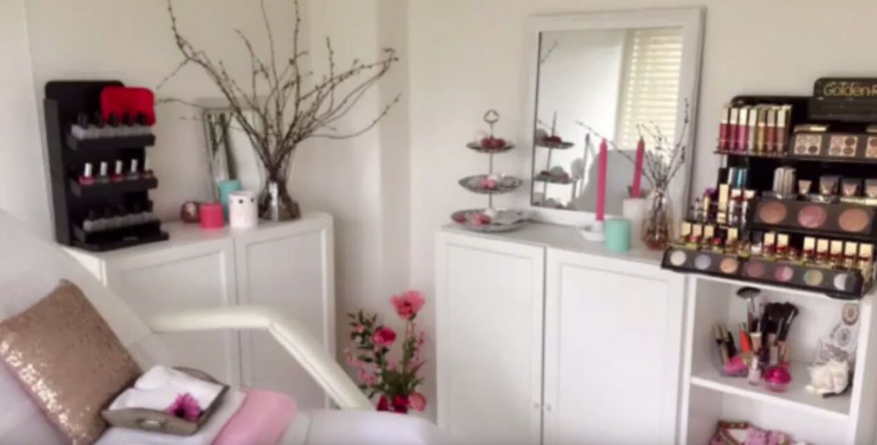 A well-organized vanity area with a mirror, makeup shelves, and a small plant.