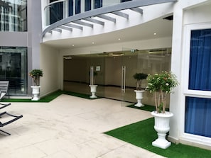 Stunning building with a curved staircase and expansive glass doors offering a glimpse into the interior.