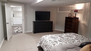 A bedroom with a bed, dresser, and television. - The Filly - 6 miles to Churchill Downs - Pets - Highlands/Cherokee Triangle (Louisville)