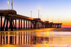 A pier extending into the water with a sunset in the background. - Amber Tide - Bright 1BR Marina Gem Ocean View (Marina Del Rey)