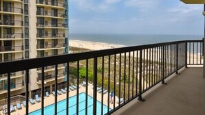 A balcony with a view of a beach and ocean. - Ocean Front Building w/ side views of Ocean and Beach, lifeguarded pool, Game Room, Gym, Tennis (Ocean City)