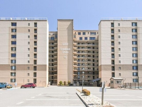 A multi-story building with a sign reading "5801 Sandpiper Drive." - Direct Ocean Front, 9th floor panoramic beach and ocean views! Large outdoor pool, (Ocean City)