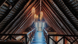 A wooden staircase leading to a high ceiling with a sloped roof and hanging light fixtures. - Aldea Kuká, Luxury Eco Boutique Hotel  (Isla Holbox)