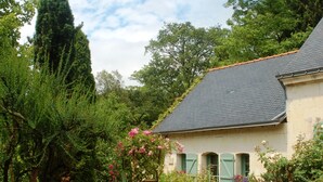 A house with a garden, a stone pathway, and a tall tree. - Luxury gites & B&B, near Saumur, in 18thC former wine estate, heated pool  (Les Bois D'anjou, Pays De La Loire)