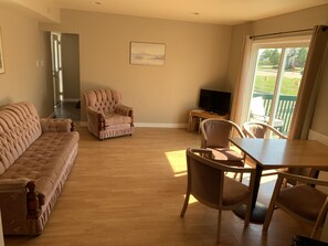 Family Triple Room | Living room | 32-inch LED TV with cable channels, TV
