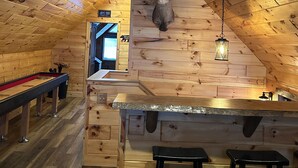A wooden interior with a deer head mounted on the wall, a bar area with stools, and a billiards table. - Best Lake in Southwest Michigan! Pontoon Boat included. Private beach frontage. (Grand Junction)