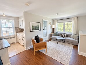A modern living room with a sofa, a coffee table, and a fireplace. - The Loft at Riverside - King Bed + Deck + Coffee Bar (Lancaster)