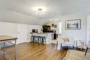 A compact living space with a kitchen, dining area, and seating. - The Loft at Riverside (Lancaster)