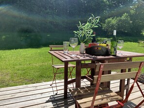 Enjoy a serene outdoor setting with a picnic table and lush surroundings.