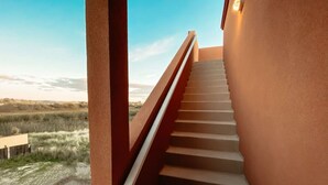 A staircase leading to a balcony with a view of a natural landscape. - Steps to the Beach! Rooftop Deck! Firepit & BBQ! (Oceano)