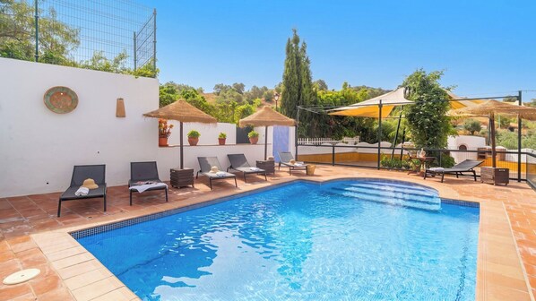 A swimming pool with lounge chairs, a pergola, and potted plants. - Espina Rural Almogía by Ruralidays (Málaga)