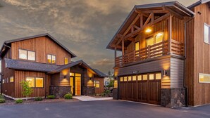 A modern two-story house with a stone foundation, wooden exterior, and a garage. - Bring your 🚲~ resort pool ~ amenities ~ trails ~ golf ~ hot tub ~ Bend ~ 🐶 (Bend)