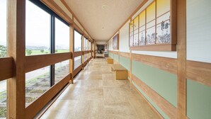 A long corridor with wooden railings, large windows, and a tiled floor. - Sanuki mansion (Kanonji)
