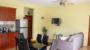 A compact living space with a kitchen, dining area, and seating area. - Cozy Single Apartment (Castries)