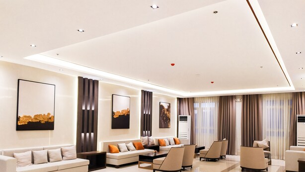 A modern living room with a sofa set, armchairs, and a coffee table. - Sotogrande Neopolitan Hotel (Quezon City)
