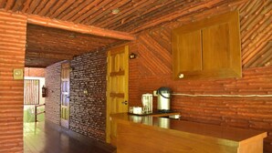 A wooden interior with a kitchen area, including a wooden counter and cabinets. - Pru Valley Thaley Tai Resort (Chumphon)