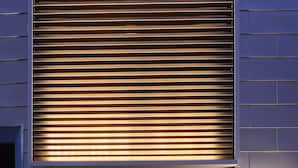 A hotel entrance with a glass door, a wooden slatted awning, and a digital keypad lock. - Koti Sopo Universal Bay 1 by Liaison (Osaka)