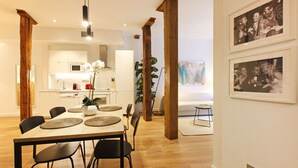 A modern dining area with a wooden table, black chairs, and woven placemats.