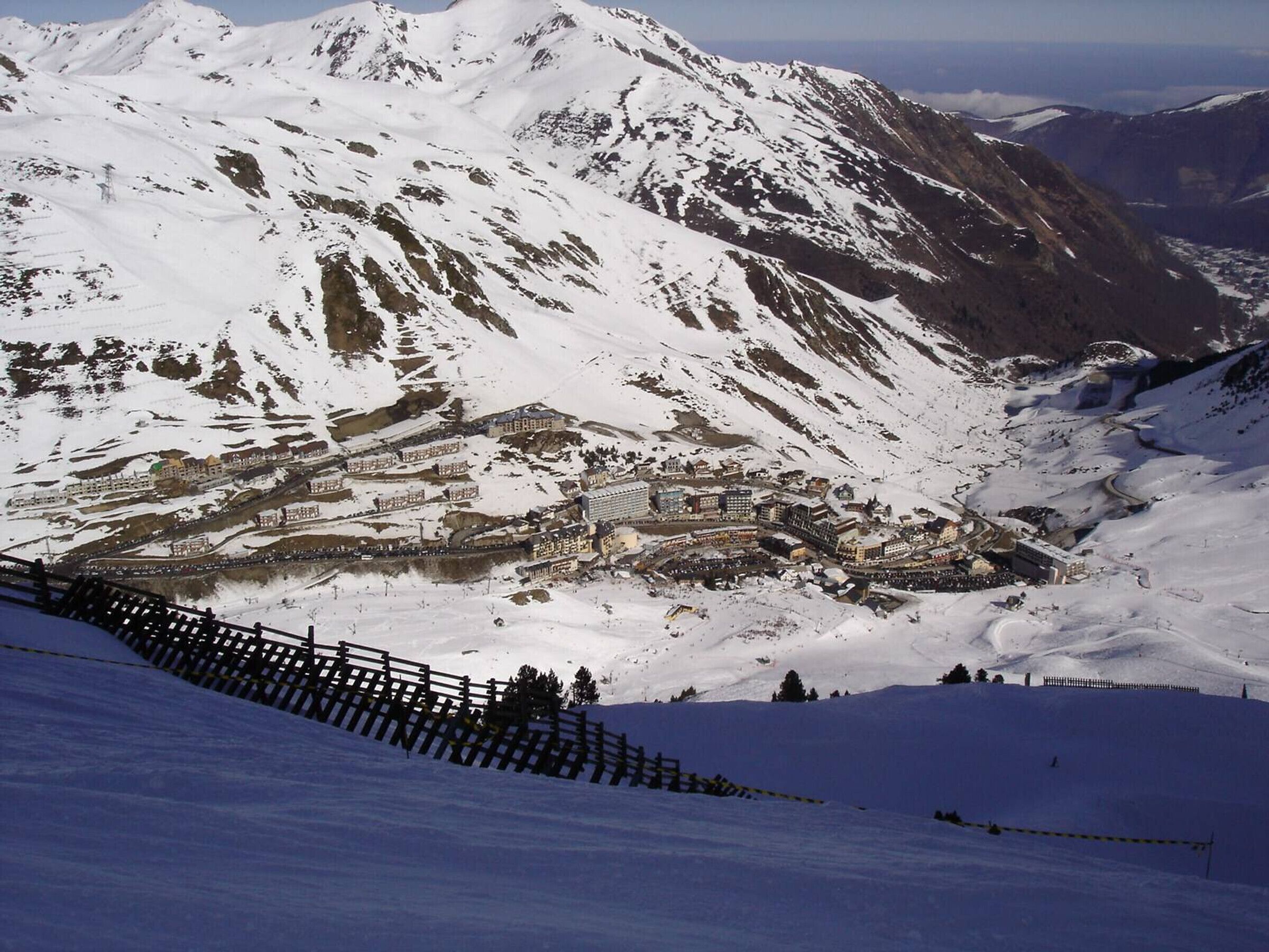 A snow-covered mountain with a town nestled in a valley.