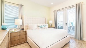A neatly arranged bedroom with a large bed, bedside tables, and curtains. - Charming Cottage 3 Miles from Disney with Margaritaville Resort & Island H2O. (Kissimmee)