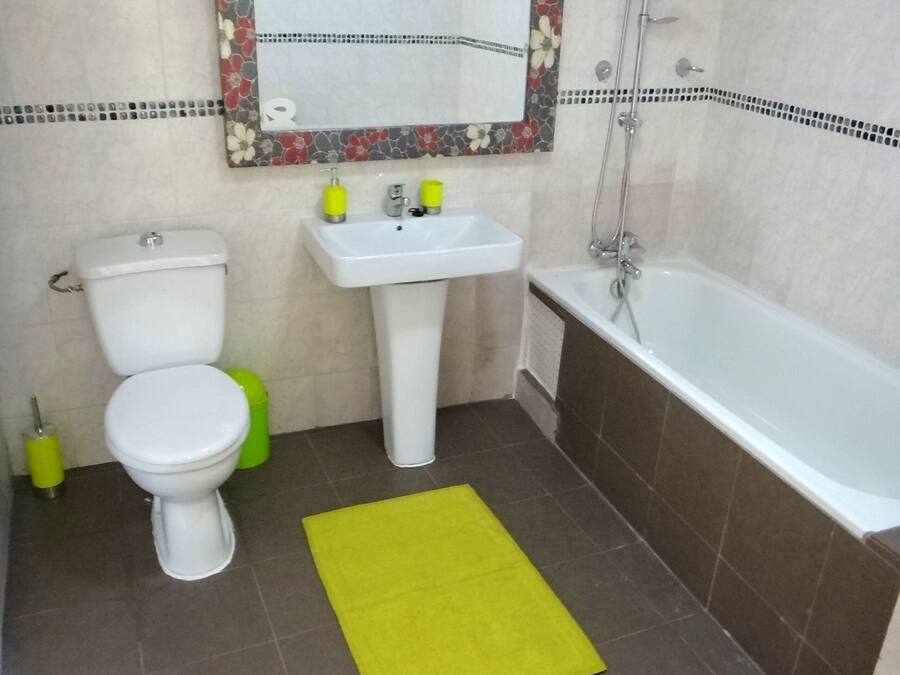 A bathroom with a toilet, sink, and bathtub.
