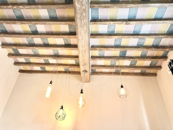 A room with exposed wooden beams and a checkered ceiling pattern.