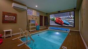 An indoor pool with a no diving sign, a pool rules sign, and a 'Merry Christmas' decoration. - Reindeer Bay: Private Pool, Amazing Views, Games (PIgeon Forge)