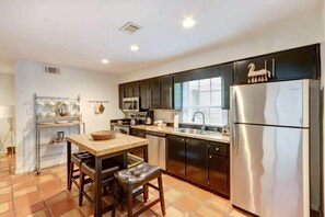 Enjoy cooking in this well-equipped kitchen with a central island and bar stools.