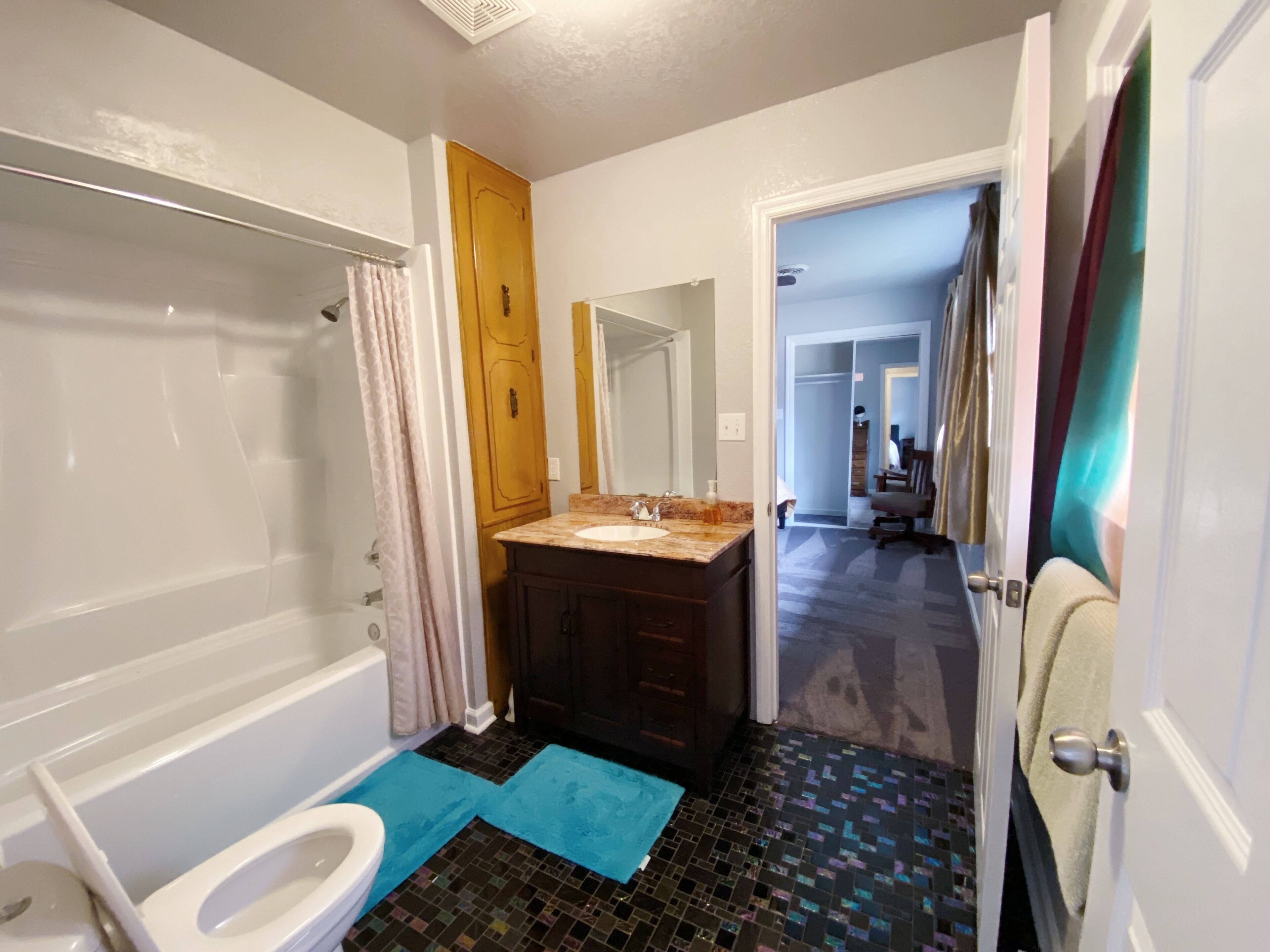 A bathroom with a bathtub, toilet, and sink.