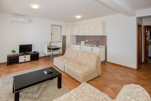 Appartement Confort | Coin séjour | Télévision à écran plat de 40 pouces avec chaînes par câble, télévision