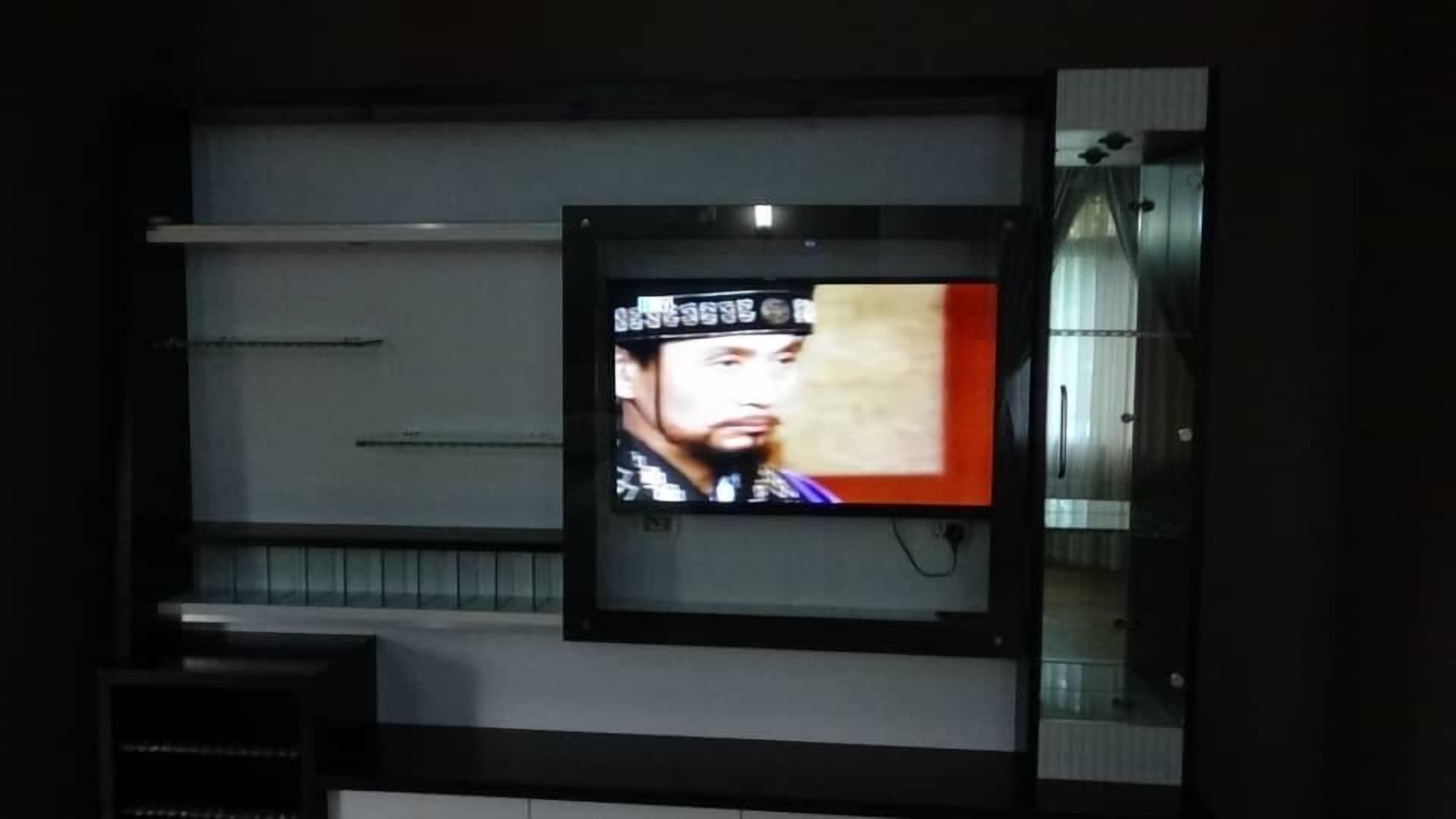 A television mounted on a wall with a modern design, featuring a large screen and a sleek frame.