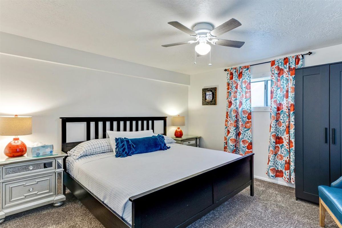 Queen bedroom with floral curtains
