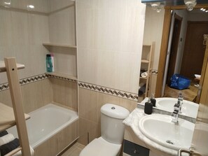 Bathtub, hair dryer, towels, soap