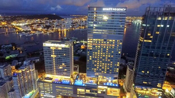 A high-rise hotel with multiple floors, a prominent sign reading "HYATT REGENCY," and a waterfront view. - Haytt-h2 Bocagrande Cartagena condominium (Cartagena)