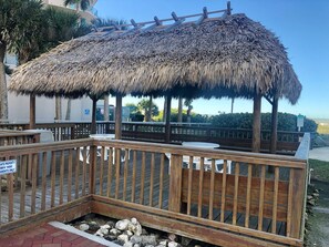 Relax in a secluded outdoor space with a deck, table, and bench.