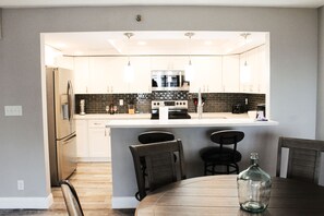 Enjoy cooking in this well-equipped kitchen with a central island, oven, and microwave.