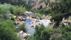 A natural landscape with a river, rocky terrain, and dense greenery. -  On Salmon River, quiet, private, house, where you can still see the milky way, (Salmon)