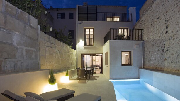 A modern outdoor living area with a pool, lounge chairs, and a dining table. - SANT SEBASTIA. Modern villa in Pollensa (Pollensa)